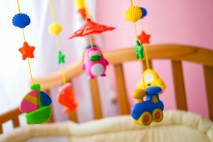 Children toys hanging from the crib